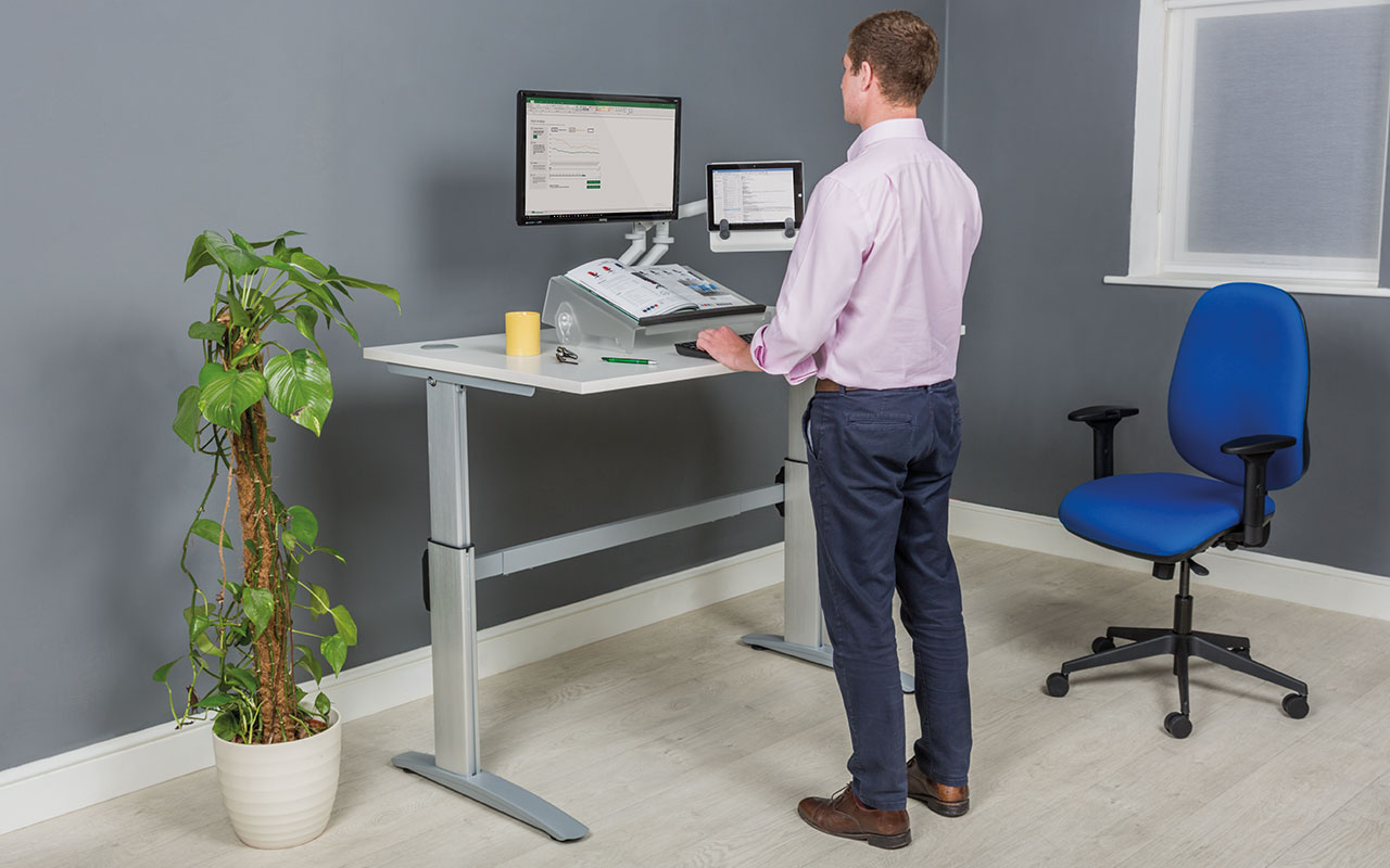 Man standing at sit-stand desk